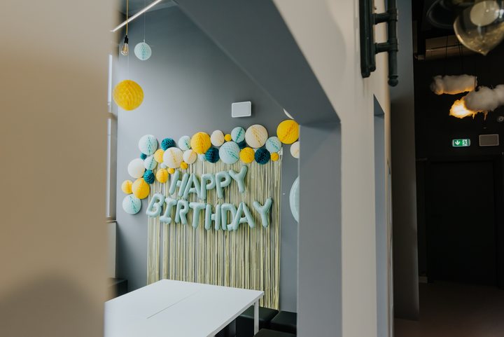 Salka urodzinowa z napisem Happy Birthday i papierowymi kulami